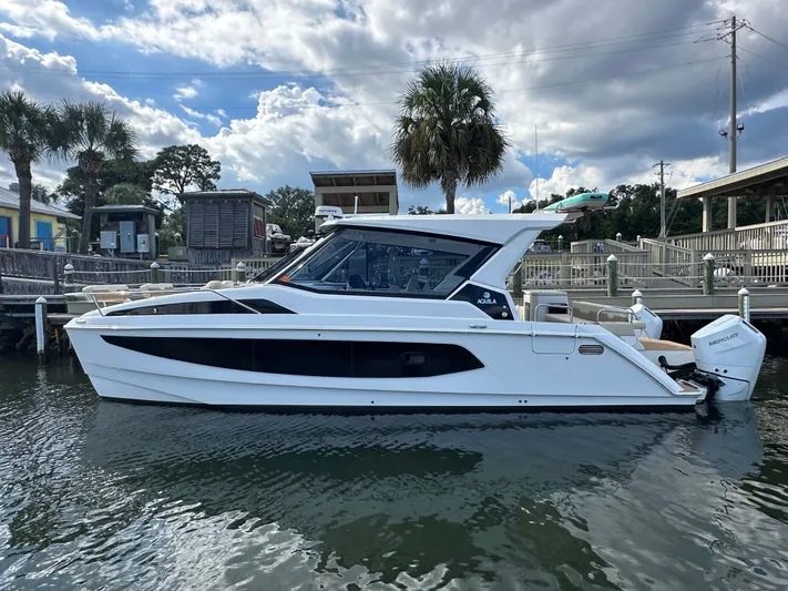  Yacht Photos Pics 2025 Aquila 36 Sport boat docked, featuring sleek design and modern amenities.