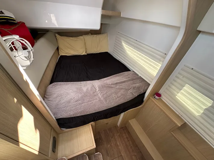  Yacht Photos Pics Cozy cabin interior of 2025 Aquila 36 Sport with bed and wooden accents.