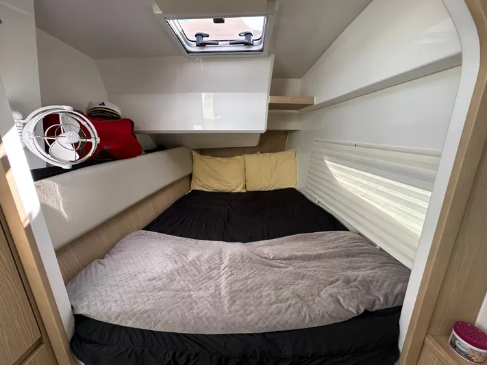  Yacht Photos Pics Cozy cabin interior of 2025 Aquila 36 Sport with bed and fan.