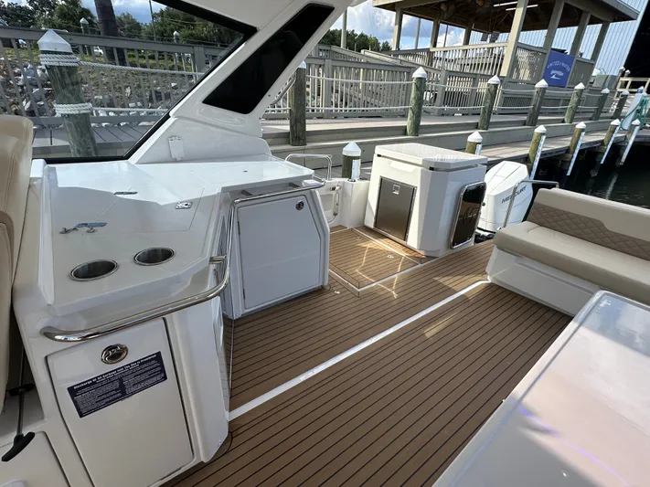  Yacht Photos Pics Aquila 36 Sport 2025 boat interior with sleek seating and modern amenities at a dock.