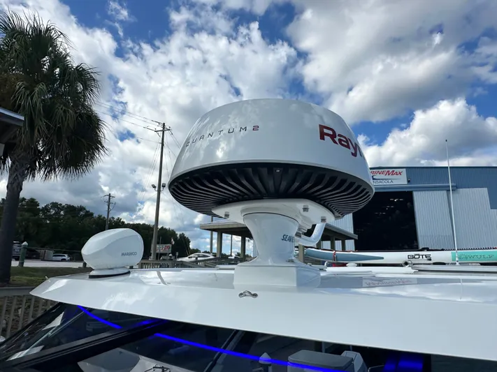  Yacht Photos Pics Radar equipment on 2025 Aquila 36 Sport boat under a partly cloudy sky.