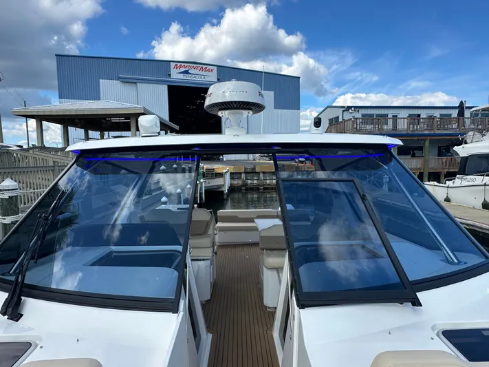  Yacht Photos Pics 2025 Aquila 36 Sport boat docked at MarineMax Pensacola under a blue sky.