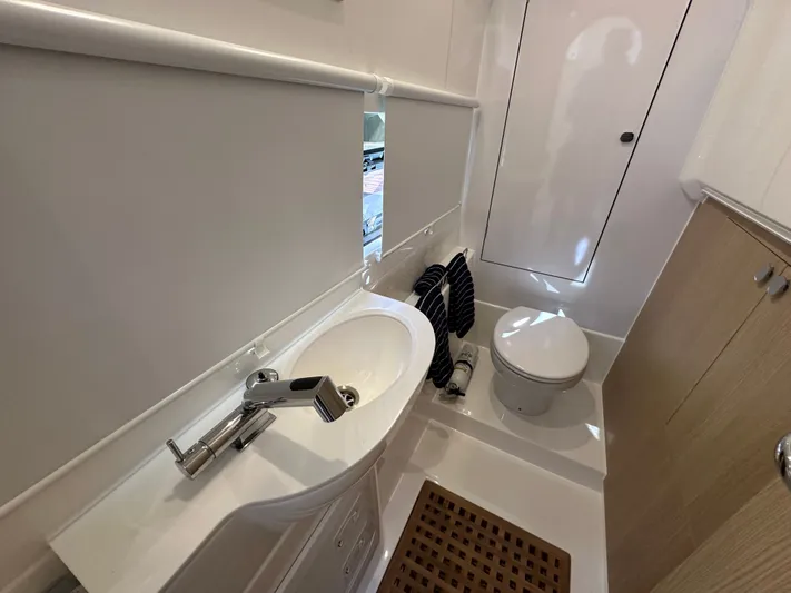  Yacht Photos Pics Bathroom interior of 2025 Aquila 36 Sport yacht, featuring modern sink and toilet.