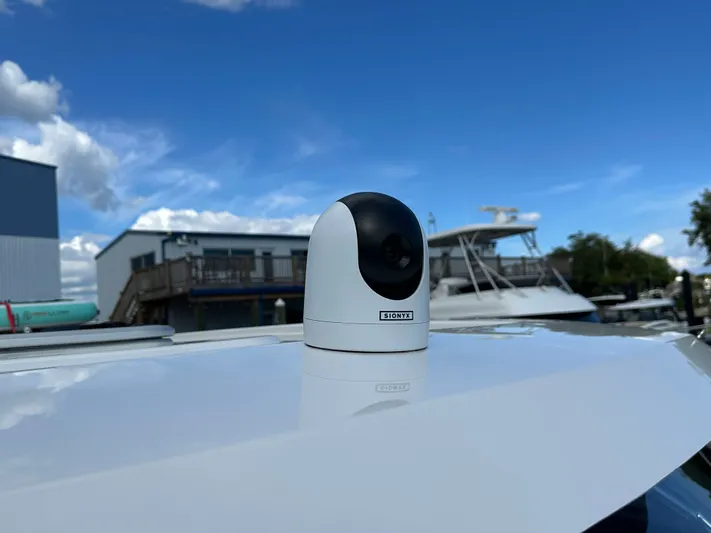  Yacht Photos Pics Camera mounted on 2025 Aquila 36 Sport boat under clear blue sky.