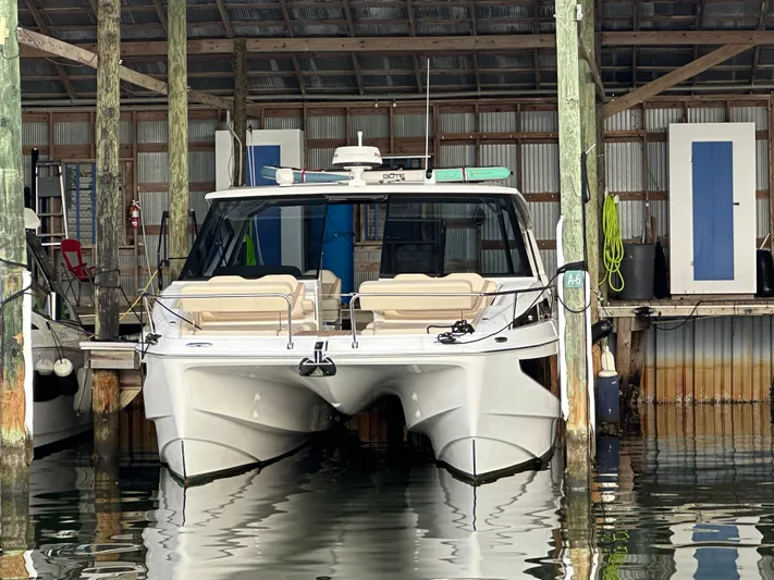  Yacht Photos Pics 2025 Aquila 36 Sport boat docked in a covered marina.