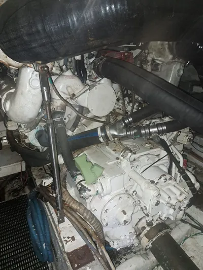  Yacht Photos Pics Engine compartment of a 1999 Hatteras 50 Convertible boat, showcasing mechanical components.