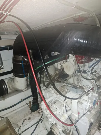  Yacht Photos Pics Engine room of 1999 Hatteras 50 Convertible yacht, showcasing complex machinery and piping.