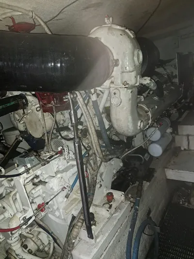  Yacht Photos Pics Engine room of 1999 Hatteras 50 Convertible yacht, showcasing complex machinery and components.