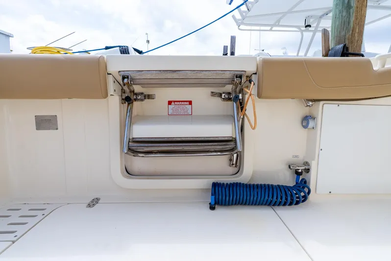 Innisfree Yacht Photos Pics 2015 Scout 300 LXF boat deck with foldable ladder and coiled hose.