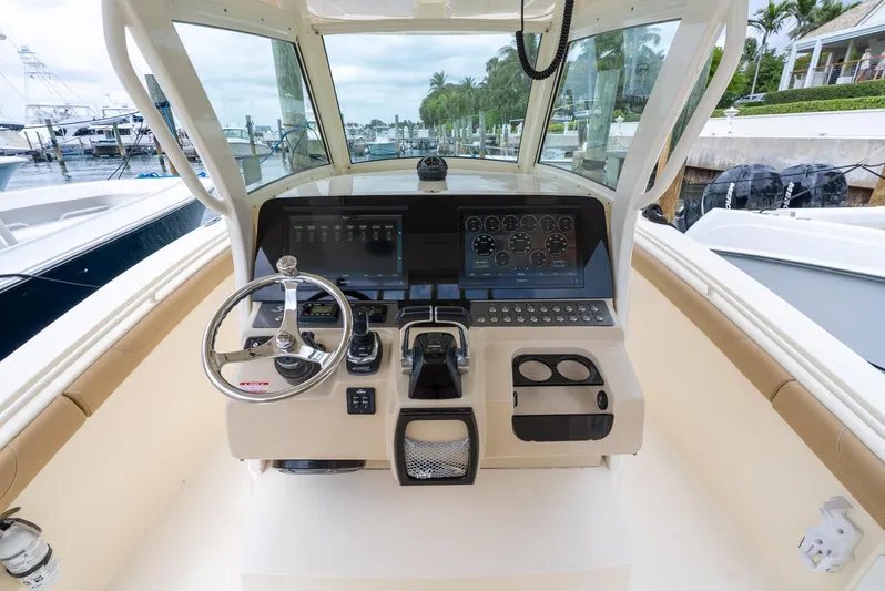 Innisfree Yacht Photos Pics 2015 Scout 300 LXF boat dashboard with steering wheel and control panel.