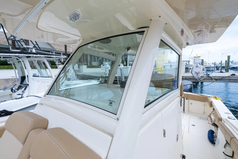 Innisfree Yacht Photos Pics 2015 Scout 300 LXF boat docked, featuring sleek design and comfortable seating.