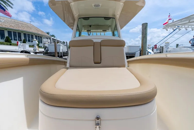 Innisfree Yacht Photos Pics 2015 Scout 300 LXF boat with beige seating, docked under a clear blue sky.