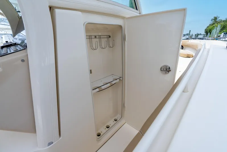 Innisfree Yacht Photos Pics 2015 Scout 300 LXF boat storage compartment with open door, showcasing interior hooks.