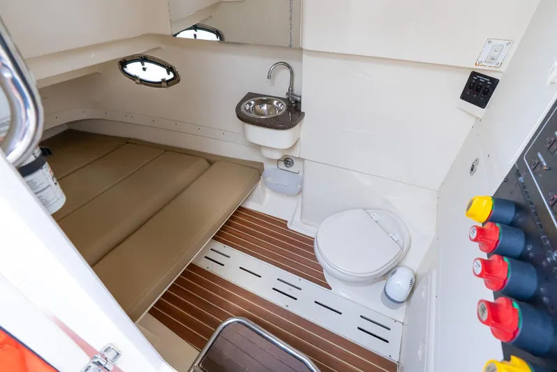 Innisfree Yacht Photos Pics 2015 Scout 300 LXF cabin interior with bed, sink, and toilet.