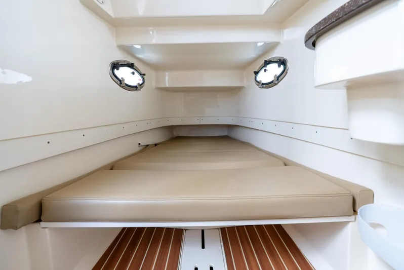 Innisfree Yacht Photos Pics 2015 Scout 300 LXF cabin interior with beige cushions and wood flooring.
