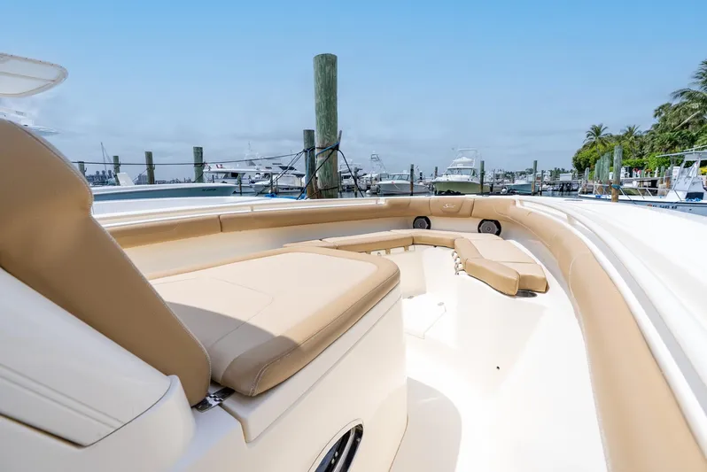 Innisfree Yacht Photos Pics 2015 Scout 300 LXF boat with beige seating, docked at a marina under clear skies.