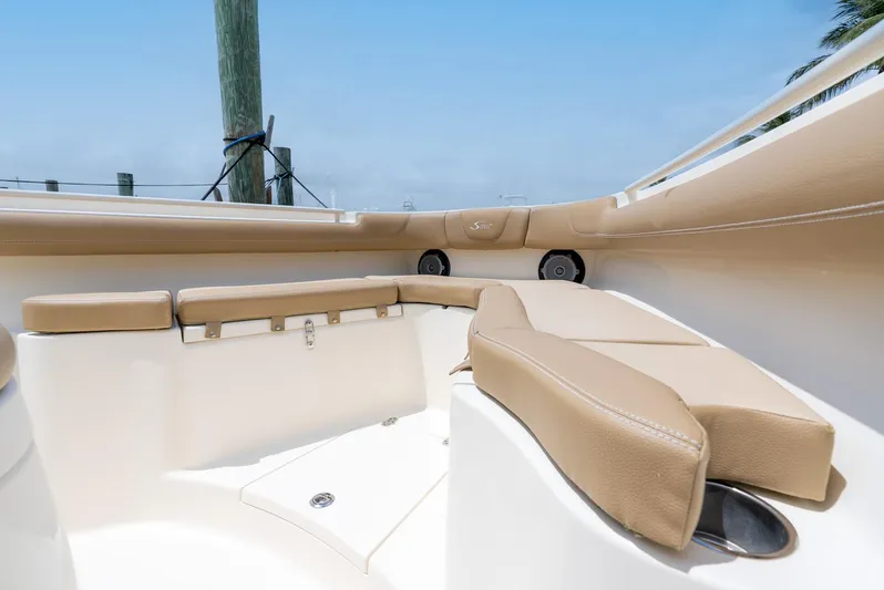 Innisfree Yacht Photos Pics 2015 Scout 300 LXF boat interior with beige seating and speakers.