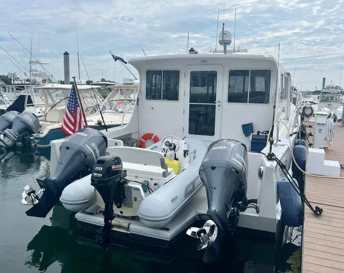 Veritas Yacht Photos Pics 2016 Wesmac 42 boat docked with twin outboard motors and American flag.