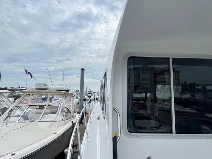 Veritas Yacht Photos Pics 2016 Wesmac 42 docked alongside other boats under a cloudy sky.