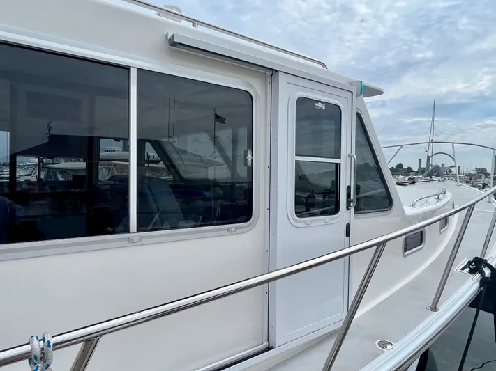 Veritas Yacht Photos Pics 2016 Wesmac 42 boat with sleek white exterior and large windows.