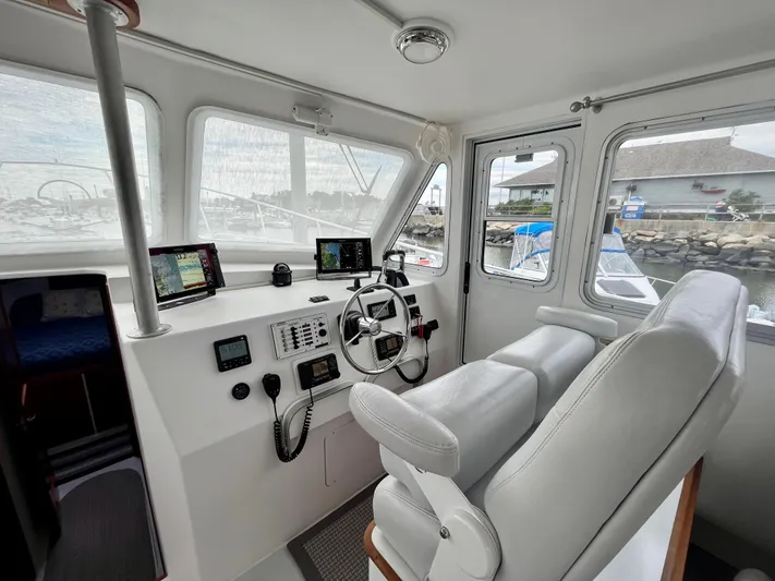 Veritas Yacht Photos Pics Interior of 2016 Wesmac 42 boat with modern navigation equipment and comfortable seating.