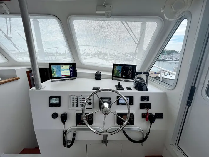 Veritas Yacht Photos Pics Wesmac 42 boat helm, 2016 model, featuring navigation screens and steering wheel.