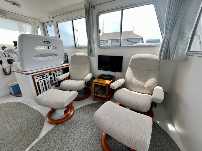 Veritas Yacht Photos Pics Interior of 2016 Wesmac 42 boat with comfortable seating and control panel.