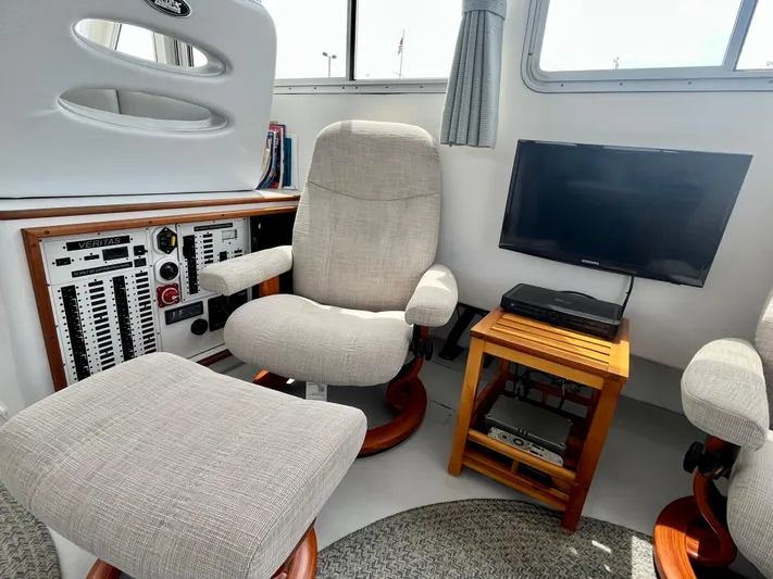 Veritas Yacht Photos Pics Cozy interior of 2016 Wesmac 42 boat with seating, control panel, and TV.