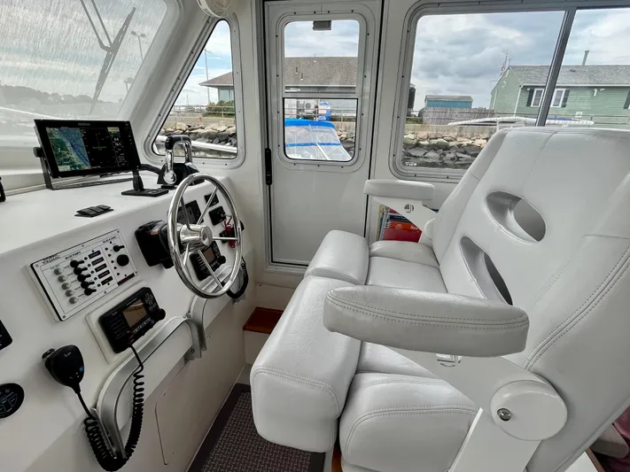 Veritas Yacht Photos Pics Interior of 2016 Wesmac 42 boat with steering wheel and navigation equipment.