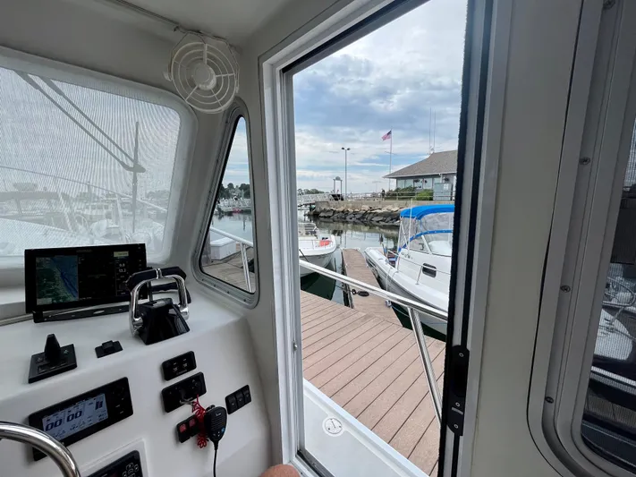 Veritas Yacht Photos Pics View from inside a 2016 Wesmac 42 boat, overlooking a marina dock.