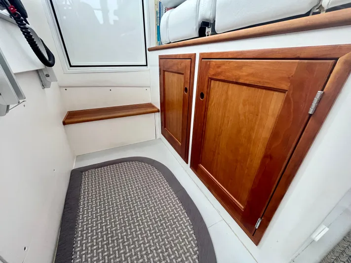 Veritas Yacht Photos Pics 2016 Wesmac 42 interior with wooden cabinets and a woven floor mat.