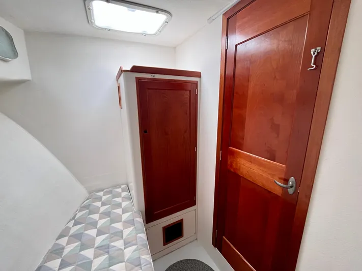 Veritas Yacht Photos Pics Cozy cabin interior of 2016 Wesmac 42 with wooden door and storage.