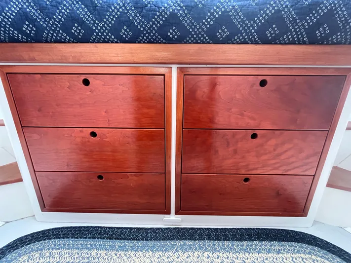 Veritas Yacht Photos Pics Wooden drawers on a 2016 Wesmac 42 boat, featuring a blue patterned cushion.