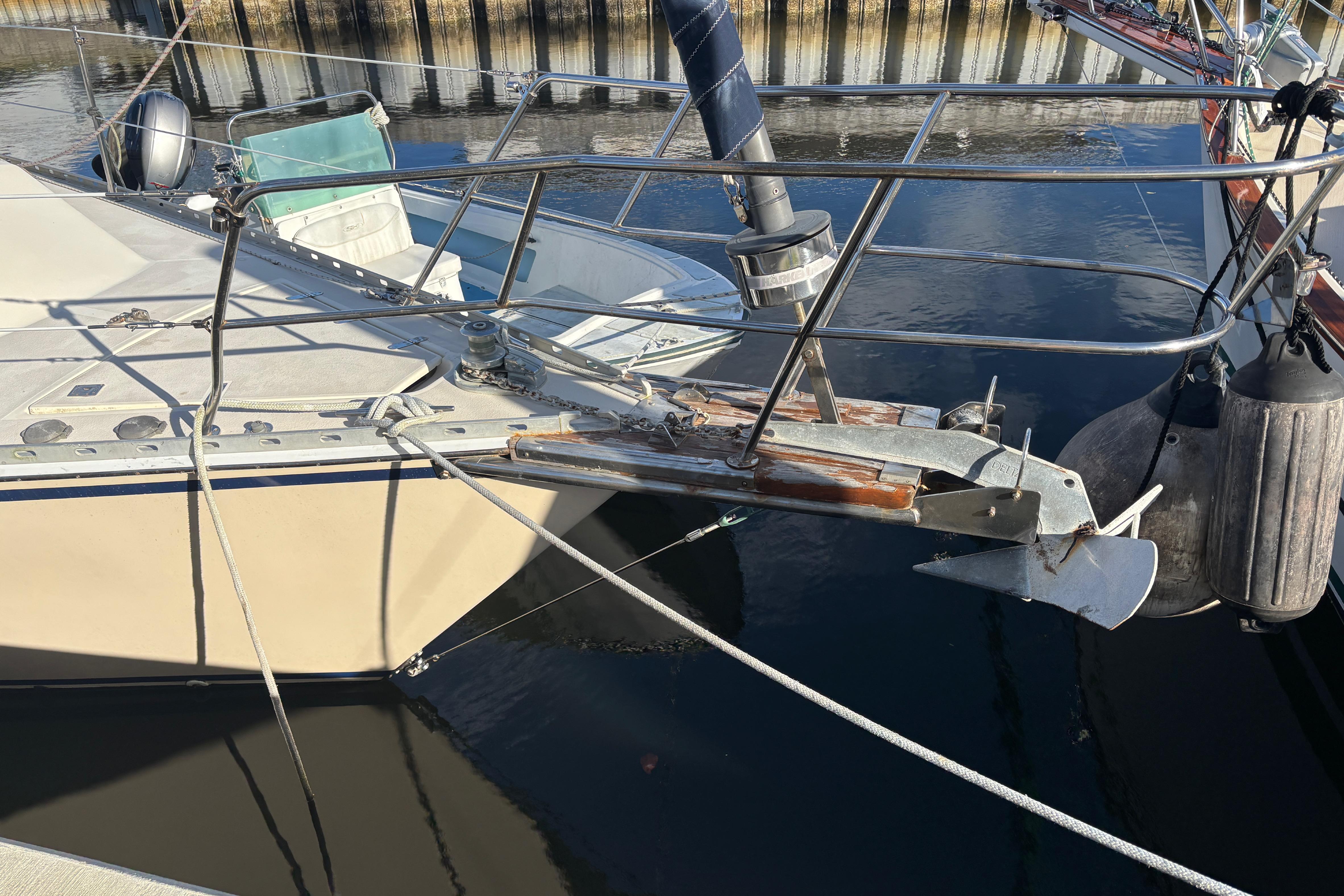 Sailboat Caliber 40LRC 1997 with anchor and fenders docked at marina.