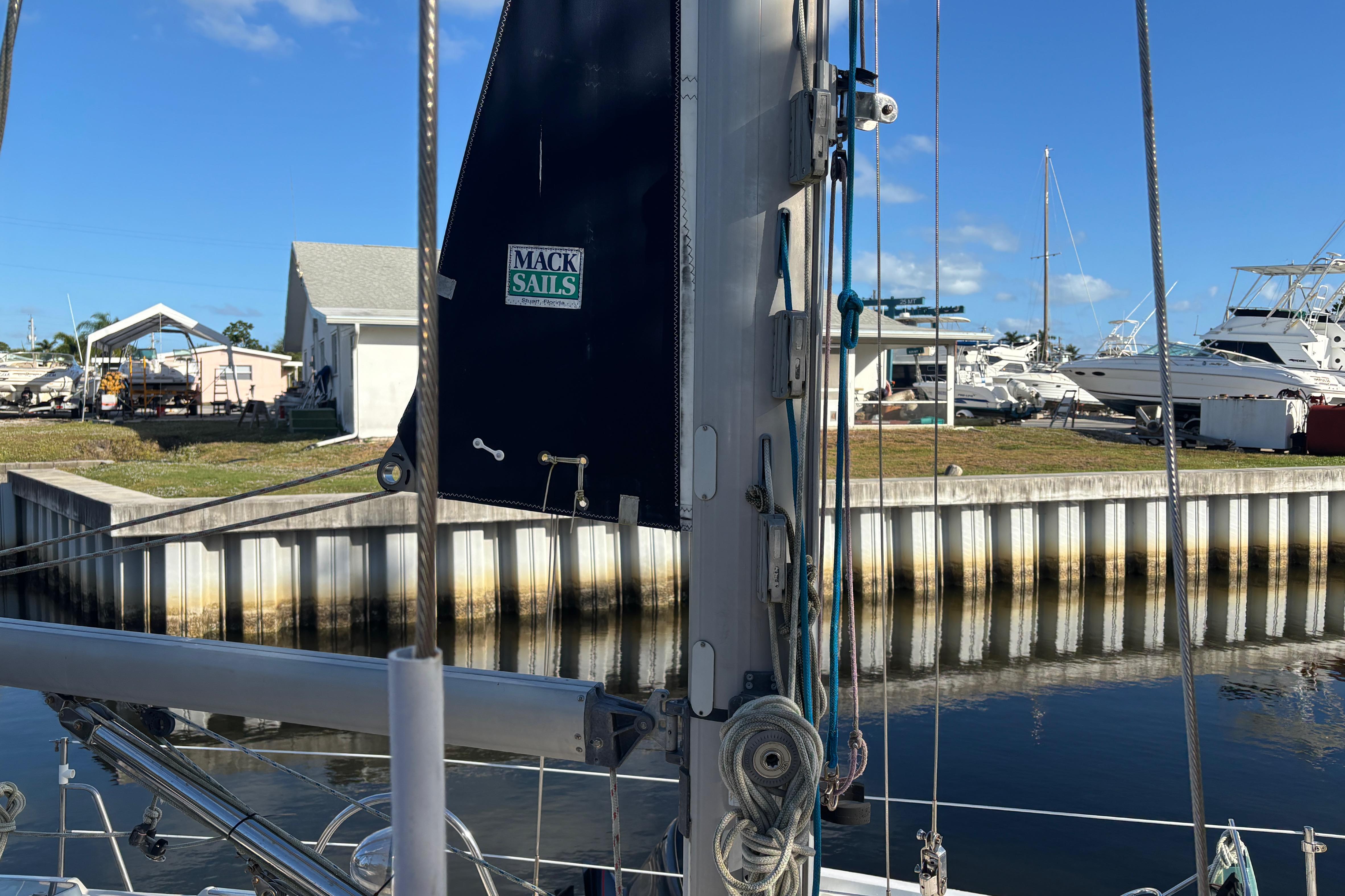 Sailboat docked with Mack Sails, Caliber 40LRC, 1997 model, in a marina setting.