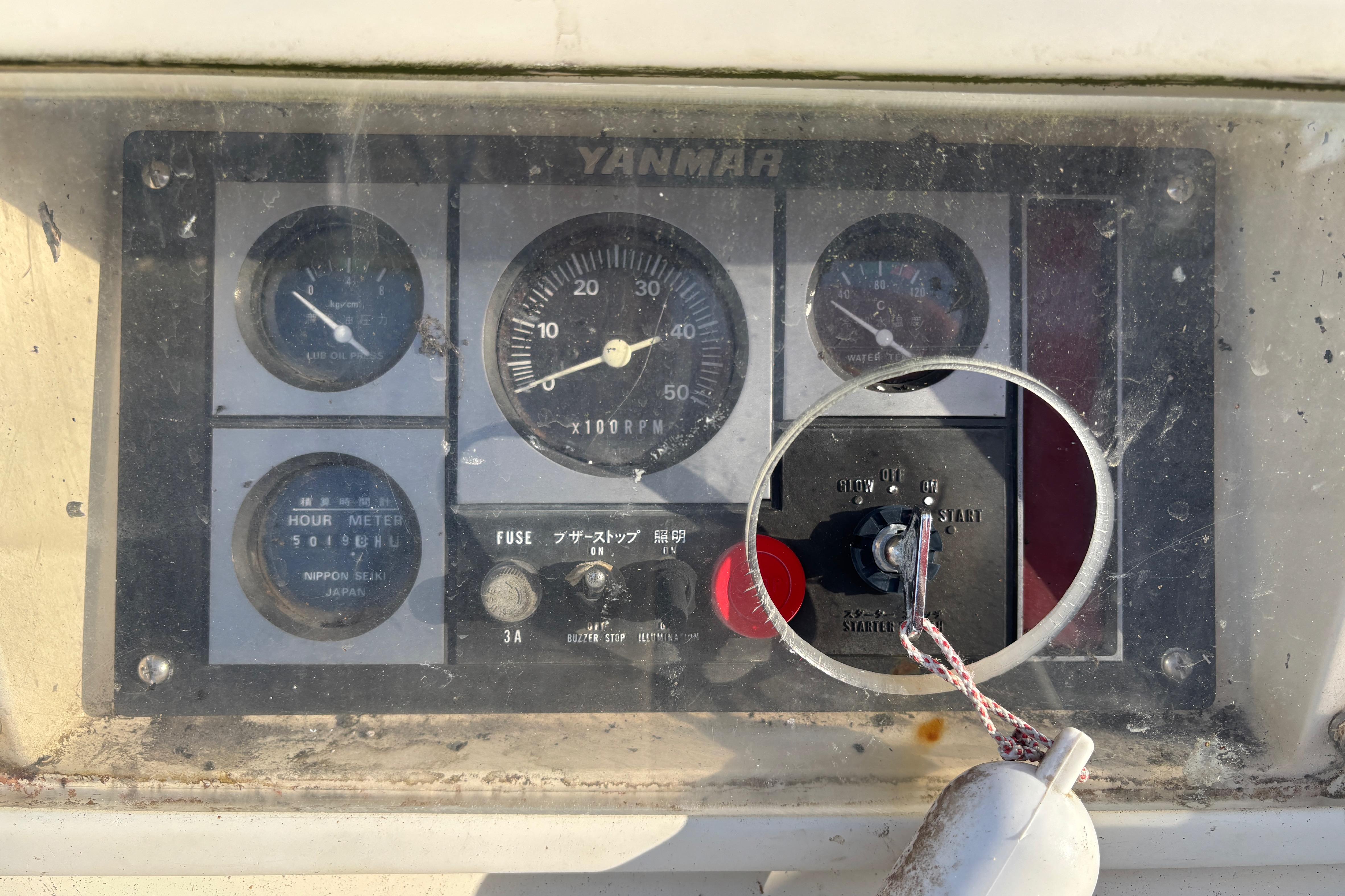 Control panel of a 1997 Caliber 40LRC with Yanmar engine gauges and switches.