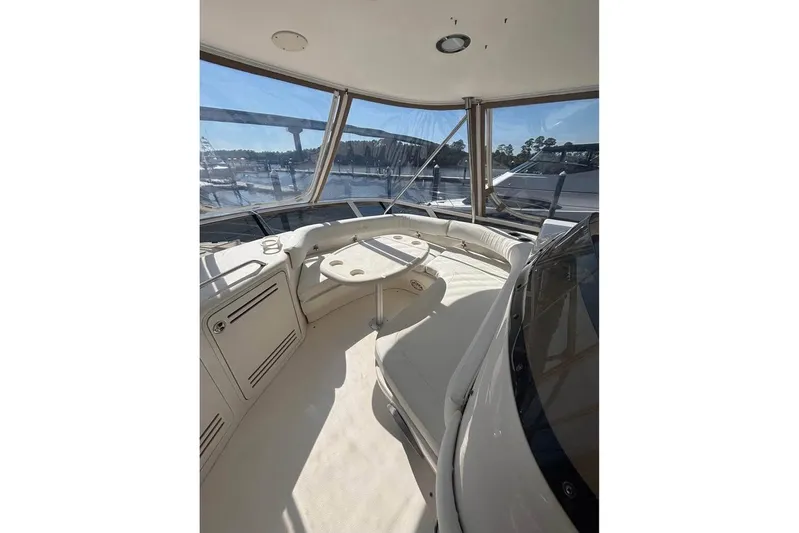  Yacht Photos Pics 2001 Sea Ray 480 Sedan Bridge interior with seating and table, marina view.