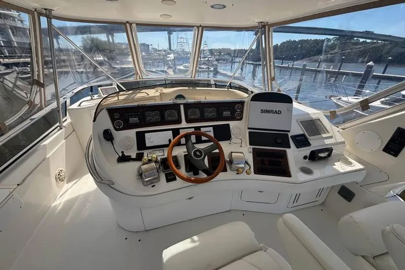  Yacht Photos Pics 2001 Sea Ray 480 Sedan Bridge helm with Simrad navigation, overlooking marina.