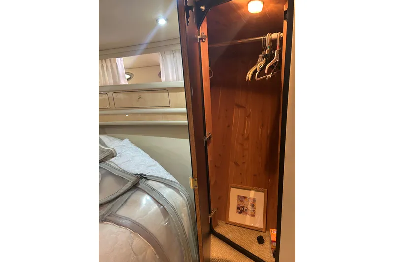  Yacht Photos Pics Interior of 2001 Sea Ray 480 Sedan Bridge showing a wooden closet with hangers.