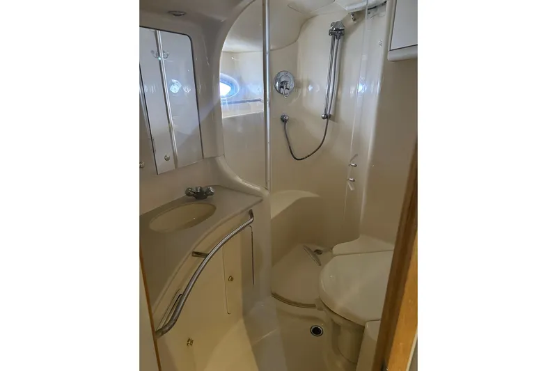  Yacht Photos Pics Bathroom interior of 2001 Sea Ray 480 Sedan Bridge yacht, featuring shower and sink.