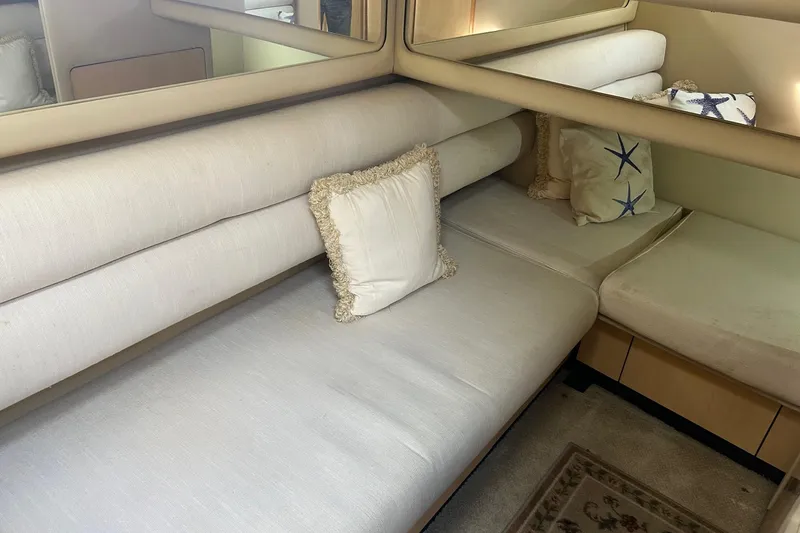  Yacht Photos Pics Interior of 2001 Sea Ray 480 Sedan Bridge with beige seating and decorative pillows.