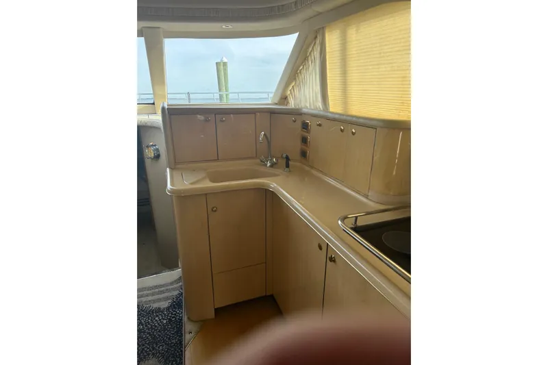  Yacht Photos Pics 2001 Sea Ray 480 Sedan Bridge yacht interior kitchen with cabinets and sink.