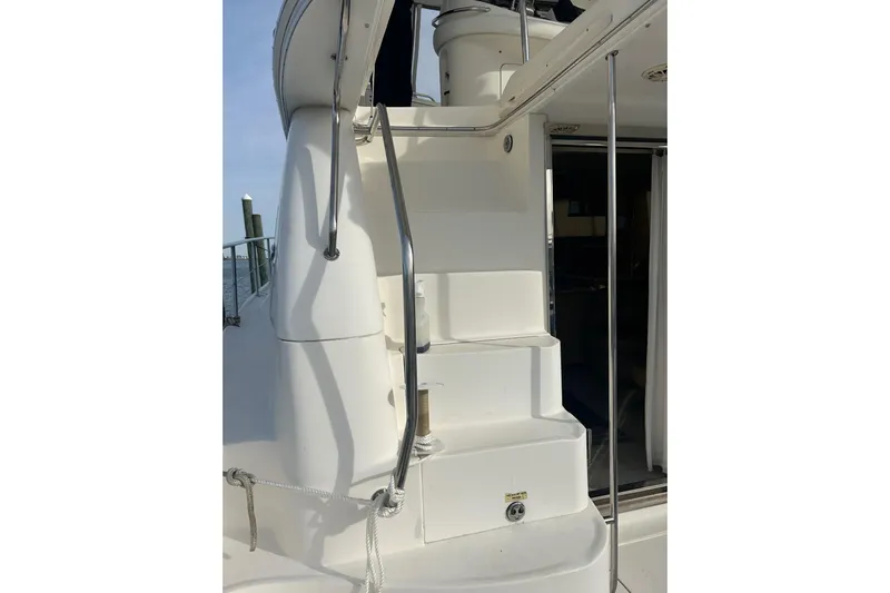  Yacht Photos Pics Staircase on 2001 Sea Ray 480 Sedan Bridge yacht, featuring sleek white design and metal railings.