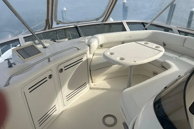  Yacht Photos Pics 2001 Sea Ray 480 Sedan Bridge yacht interior with seating and table, overlooking water.