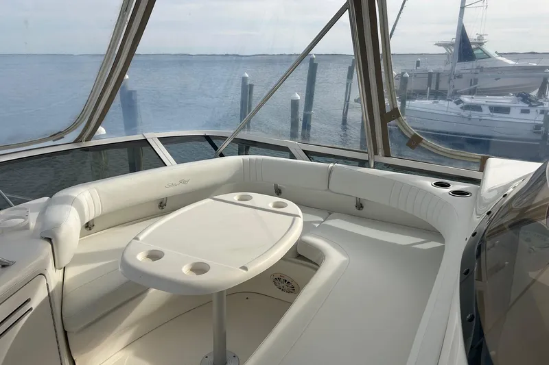  Yacht Photos Pics 2001 Sea Ray 480 Sedan Bridge yacht interior with seating and table, overlooking marina.