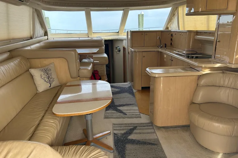  Yacht Photos Pics Luxurious interior of 2001 Sea Ray 480 Sedan Bridge yacht with beige leather seating.