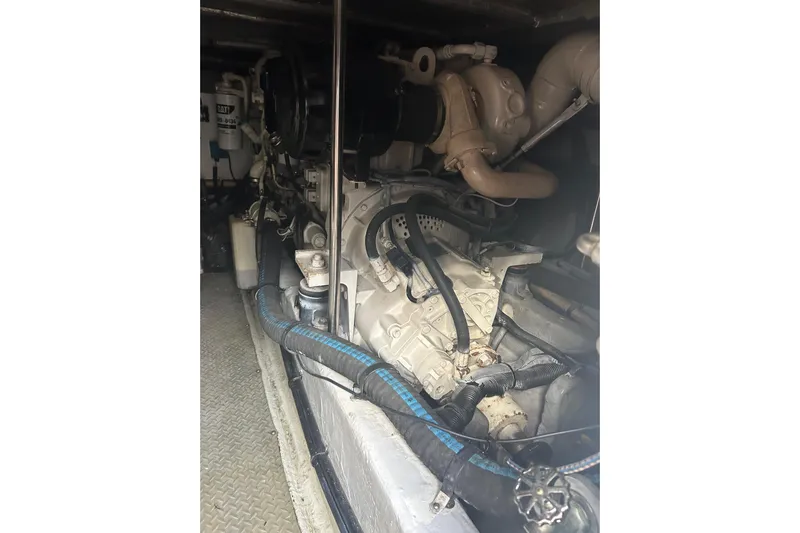  Yacht Photos Pics Engine room of 2001 Sea Ray 480 Sedan Bridge, showcasing mechanical components and piping.