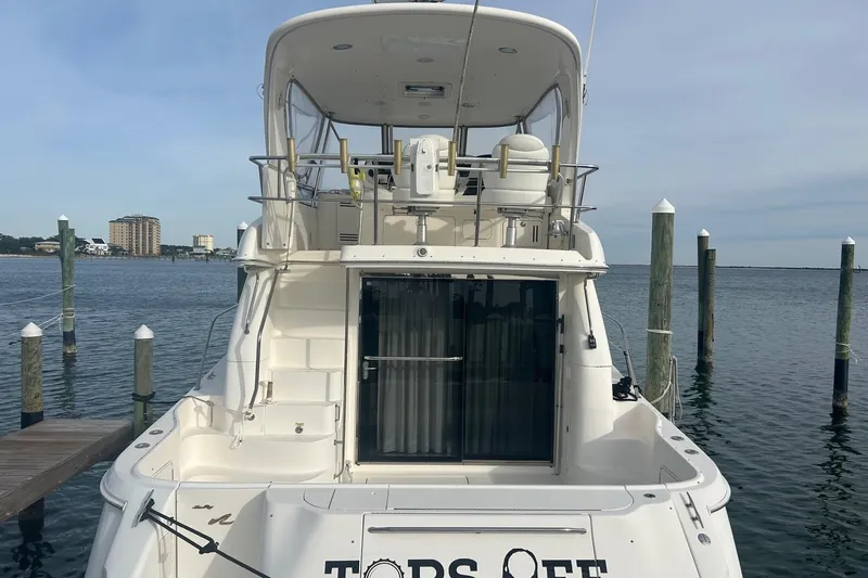  Yacht Photos Pics 2001 Sea Ray 480 Sedan Bridge yacht docked at marina, rear view.