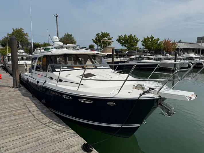  Yacht Photos Pics 2021 Cutwater C-32 C boat docked at a marina, featuring sleek design and modern amenities.