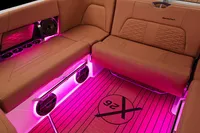 Manufacturer Provided Image: 2020 MasterCraft X26 boat interior with pink LED lighting and cushioned seating.
